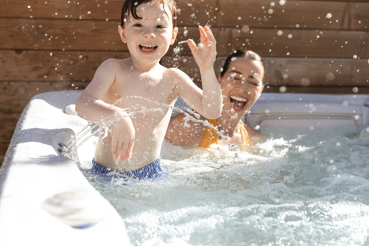 Family enjoying a Hydropool Serenity hot tub together