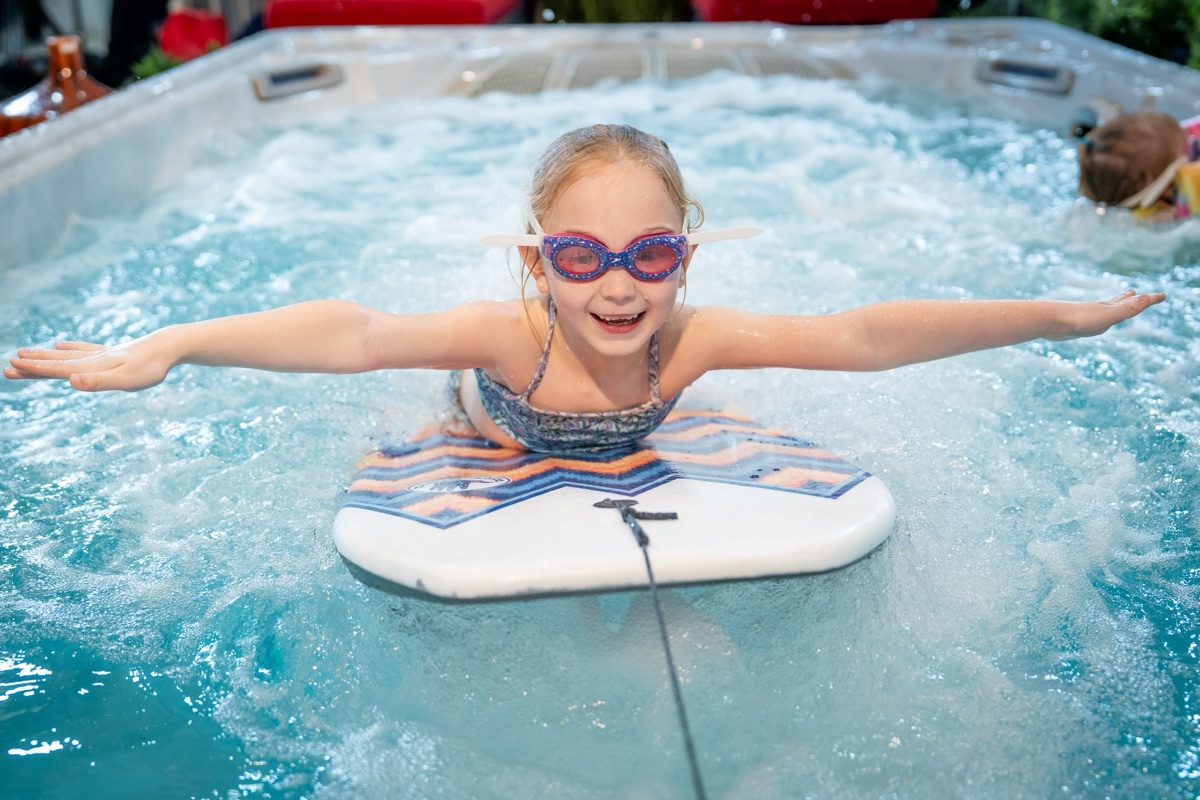 Seasonal World Hydropool swim spa &mdash; swimming against the endless current, year-round