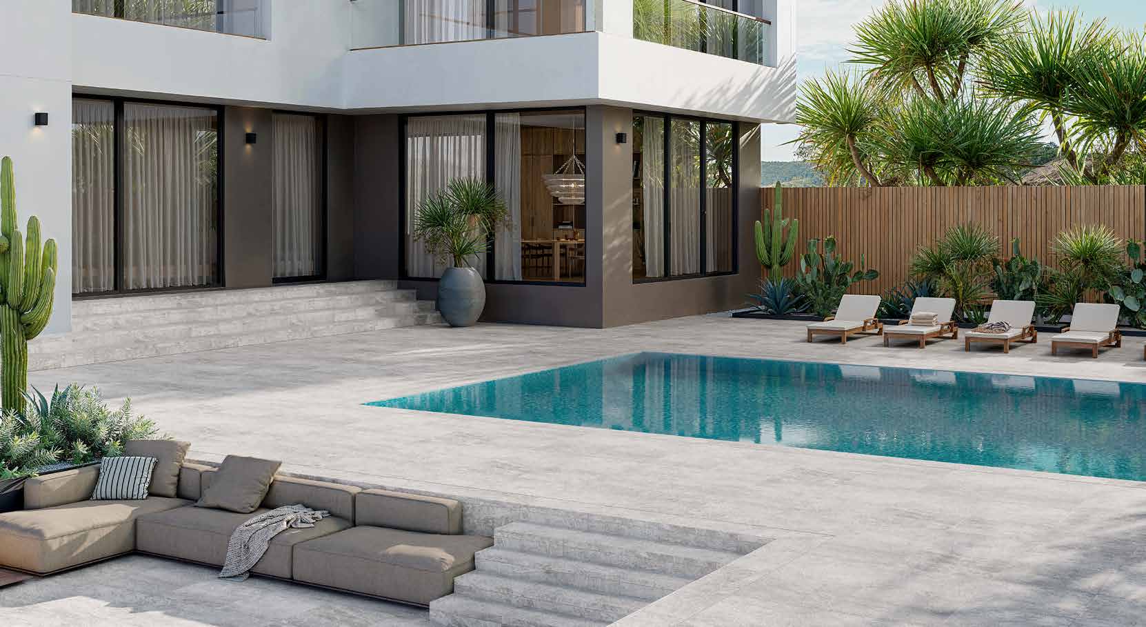 Del Conca porcelain pool deck — travertine-look pavers in residential daylight
