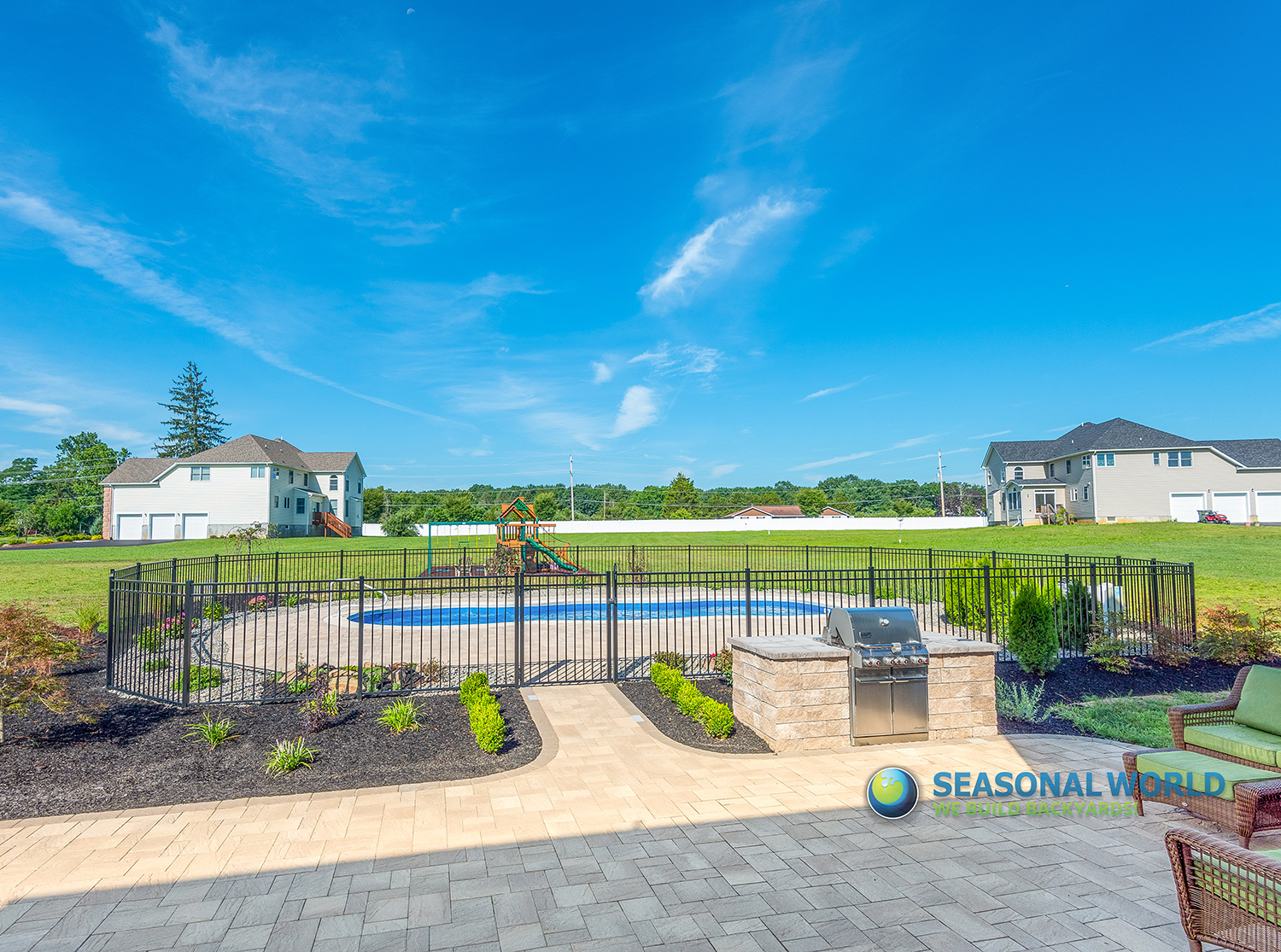 Seasonal World hardscape install — walkway with retaining wall