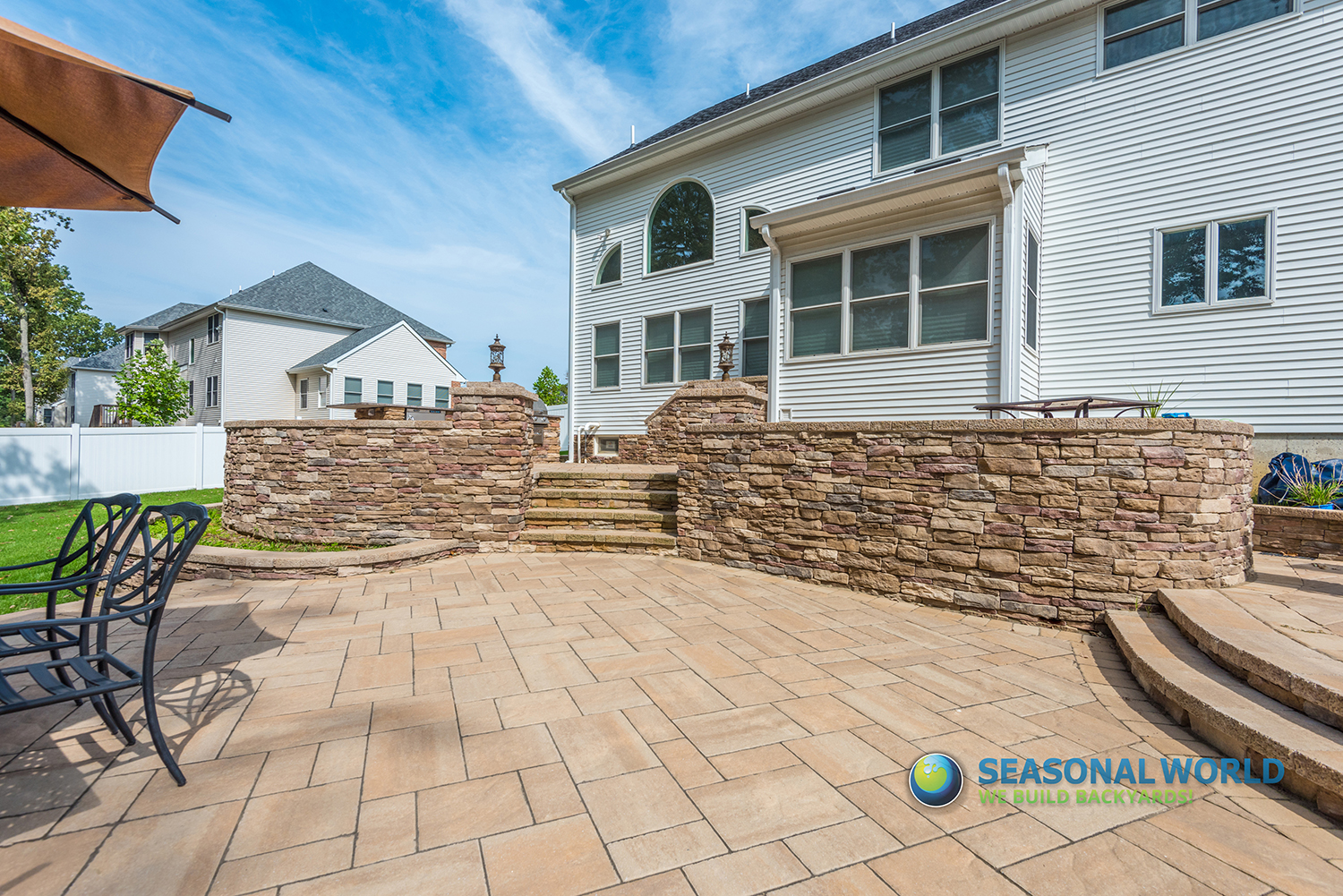 Seasonal World hardscape install — pool deck with paver coping