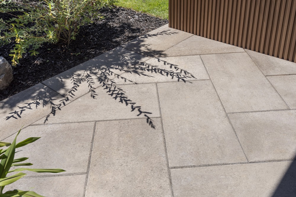 Rinox PROMA XL paver patio in Oka Beige with outdoor seating area